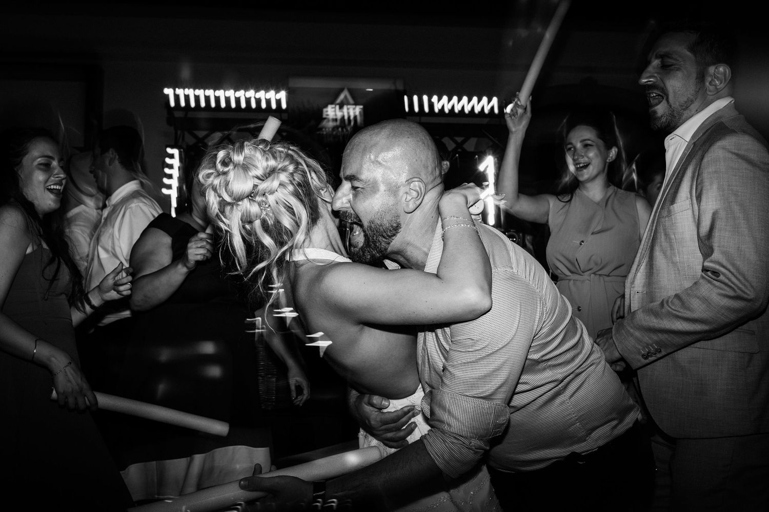 Black and white photo of a crowded dance party in a nightclub with people dancing and celebrating at Quinta da bichinha