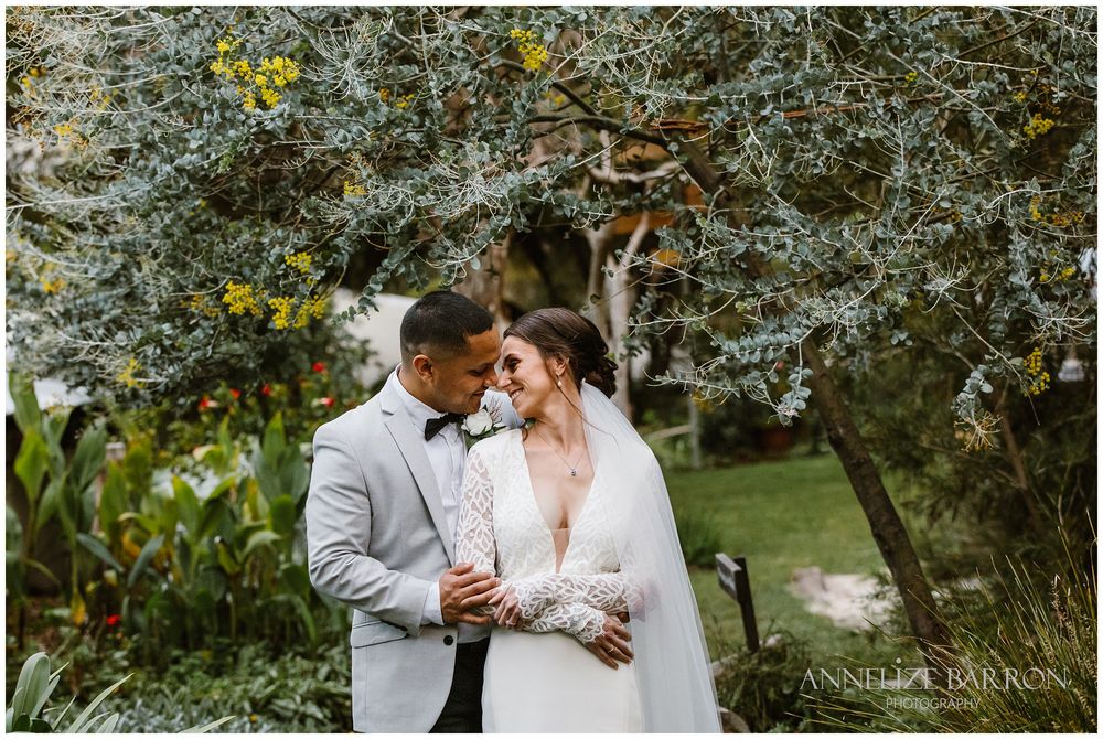 Happs Winery Wedding bride and groom snuggling in the garden