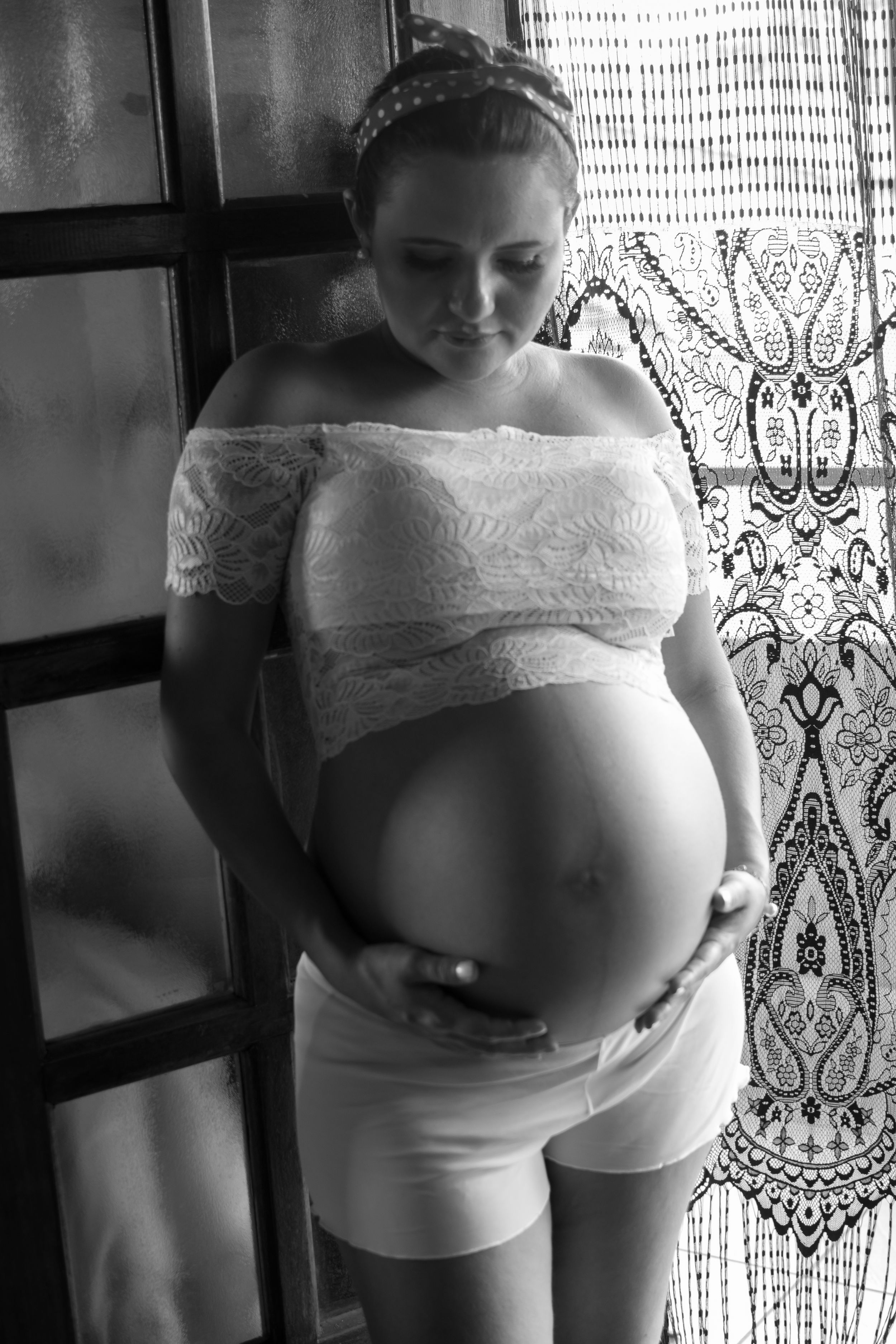 Black and white artistic pregnancy portraits with lace details and vintage style decor.