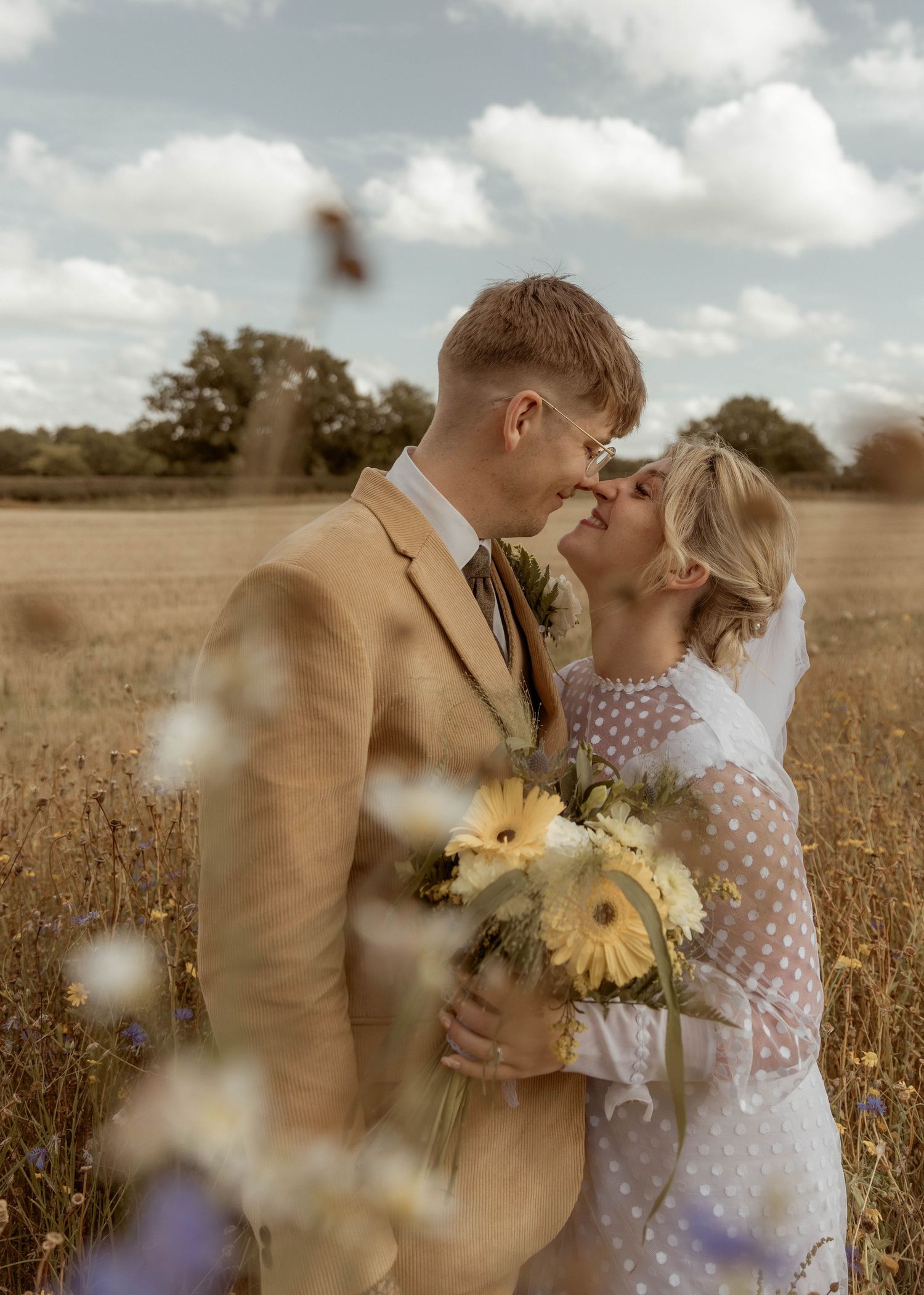 wedding couple in field with sunflowers