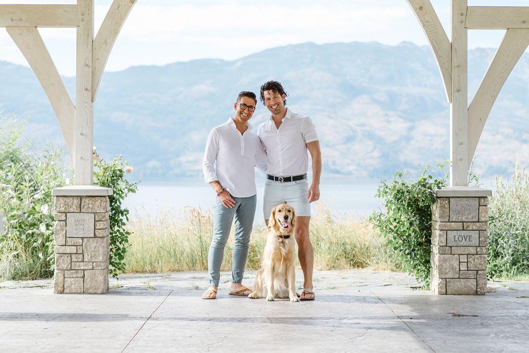 Scenic outdoor photoshoot under a white pergola with mountain landscape.