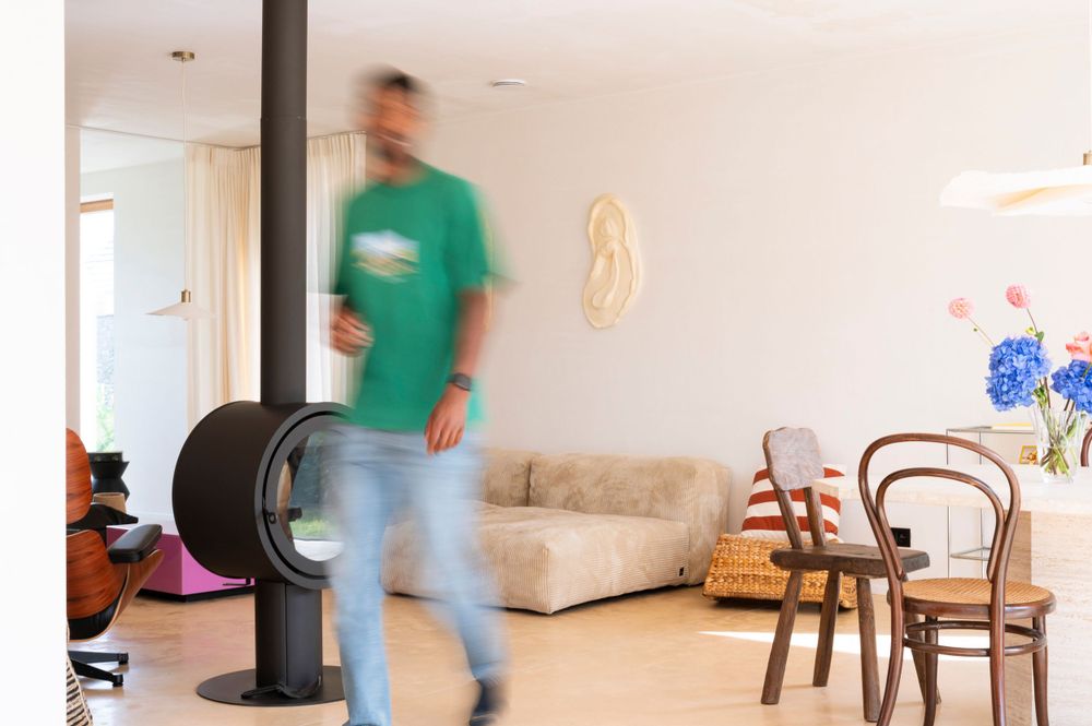Blurred motion sequence showing movement across a minimalist white interior room.