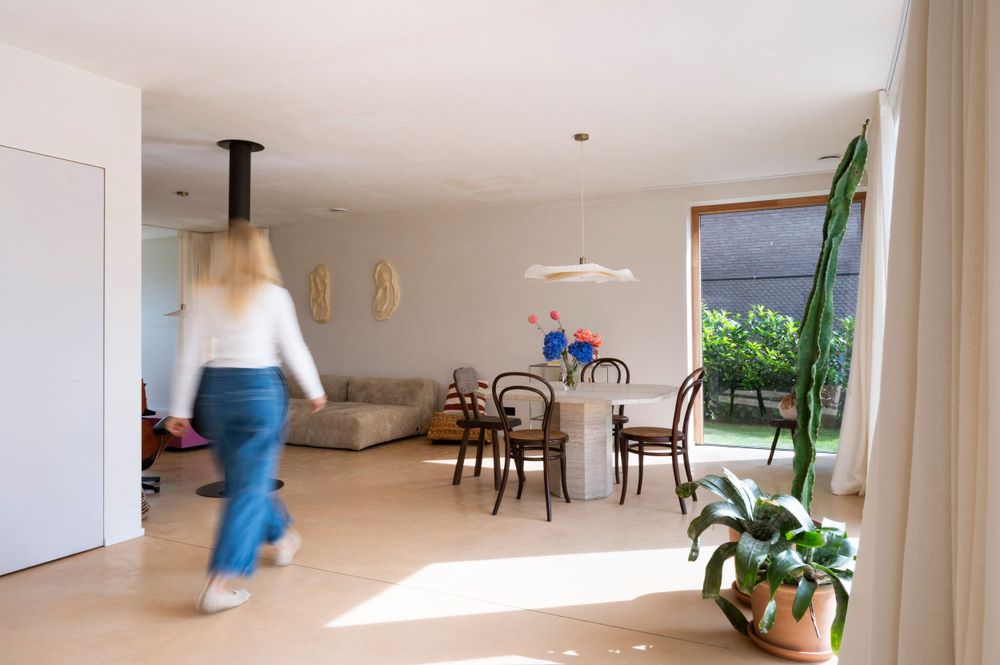 Open-concept living area with natural light streaming through large windows.