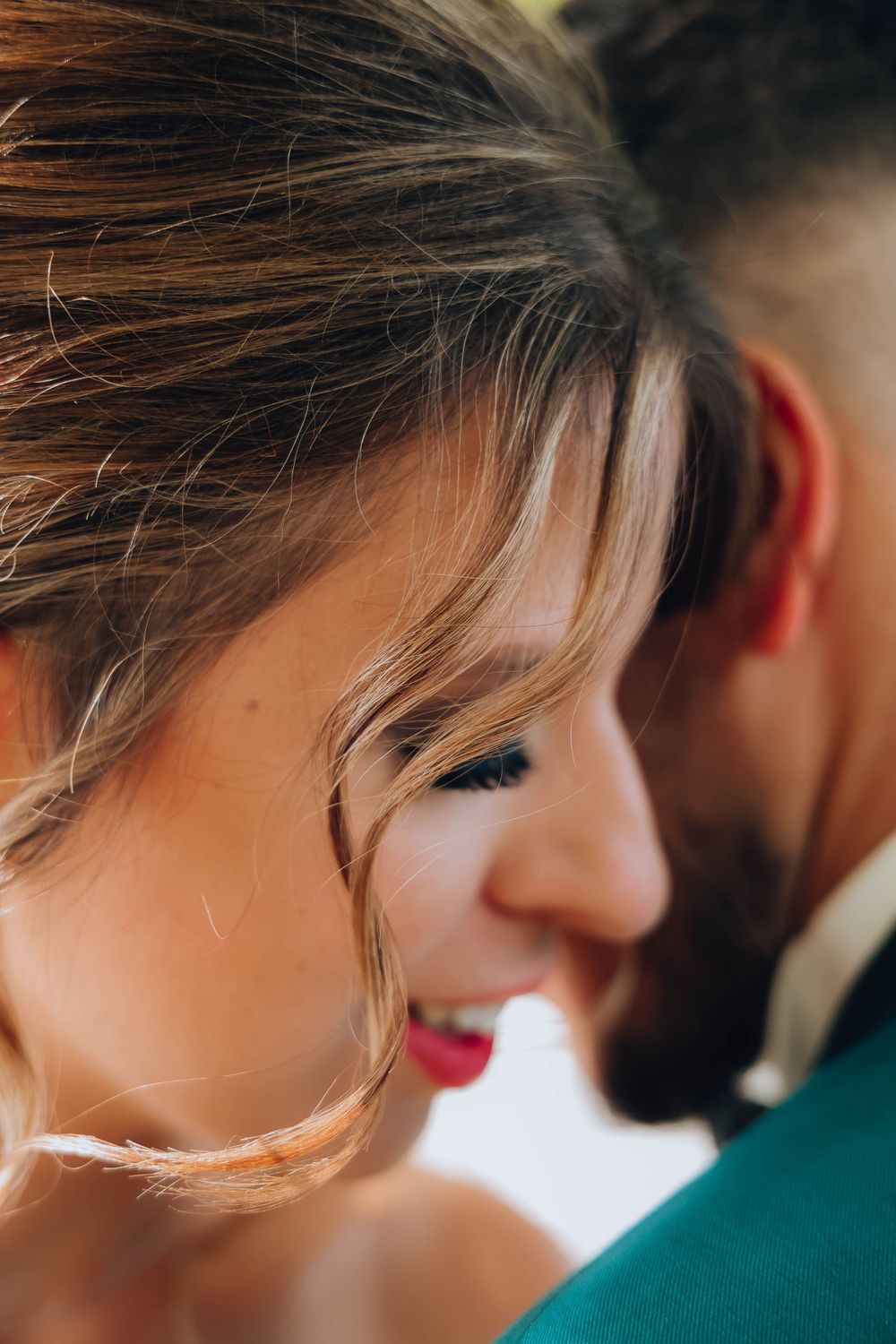 Intimate close-up portrait with soft lighting and natural makeup details.