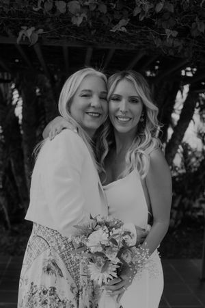 Black and white portrait of wedding party members sharing a happy moment.