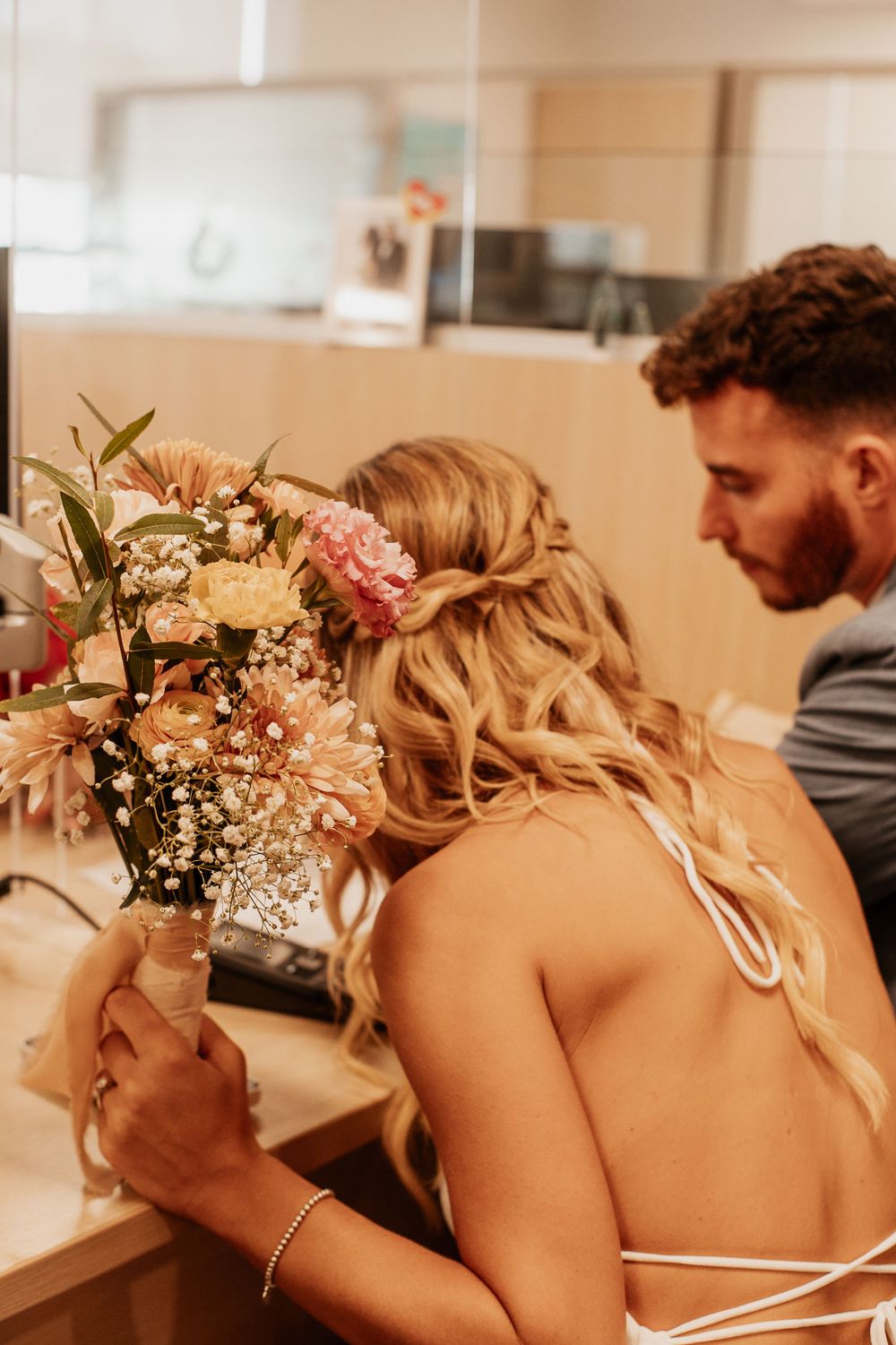 Romantic moment with bridal bouquet featuring pink and white flowers.