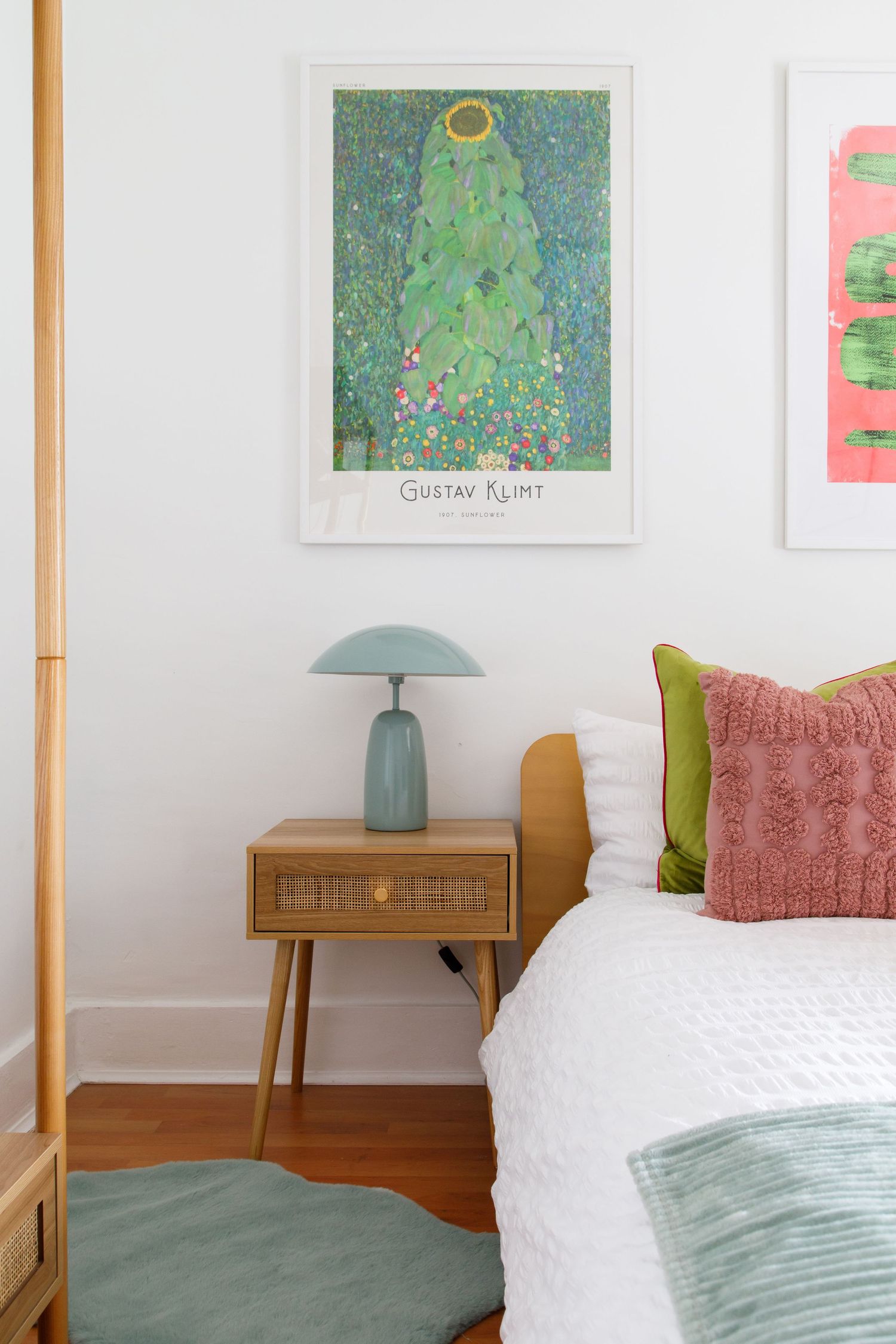 Cozy bedroom corner with vintage nightstand, turquoise lamp, and Gustav Klimt art print taken during an interiors/lifestyle photoshoot.