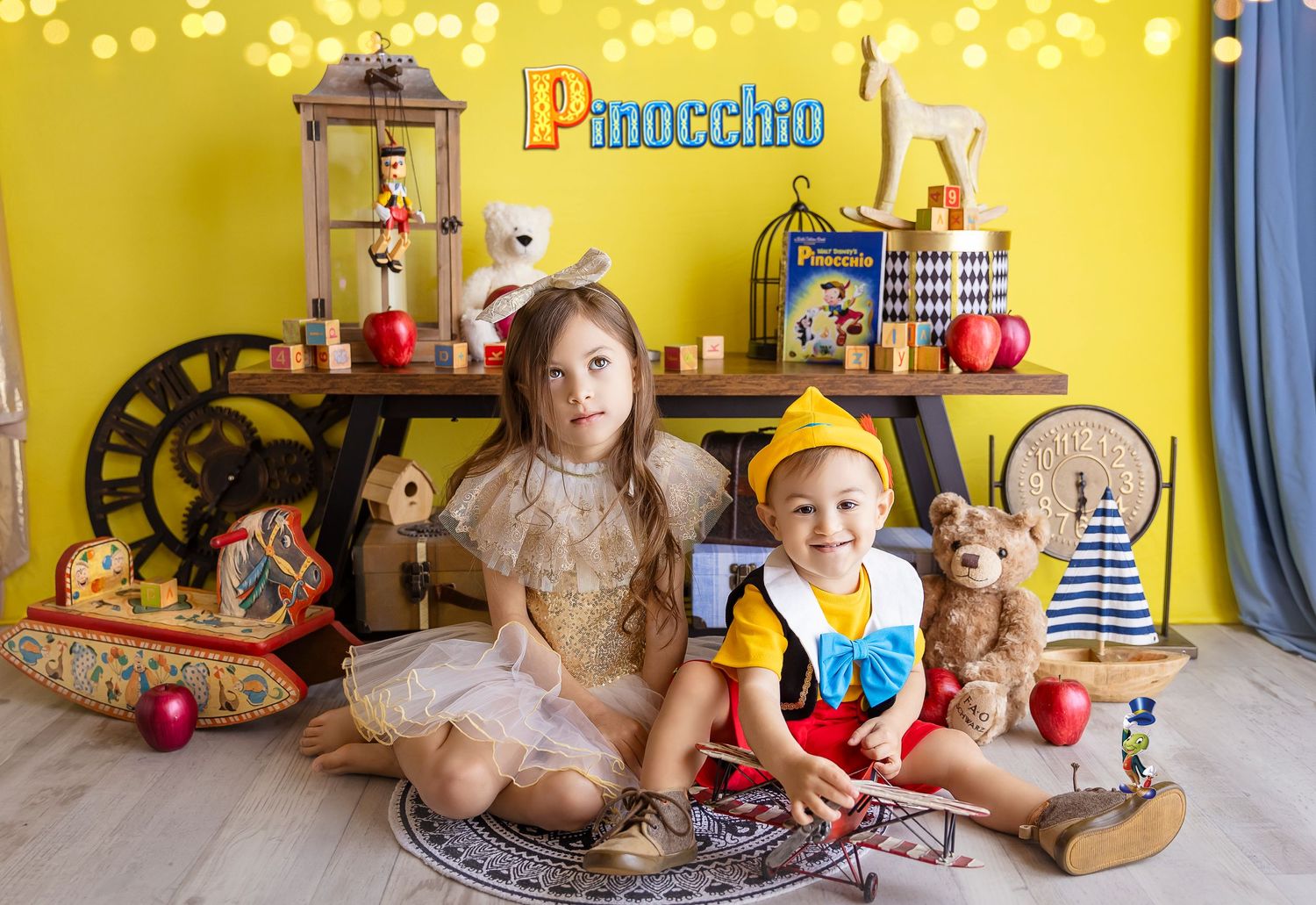 siblings posing for pinocho session toy room child photography