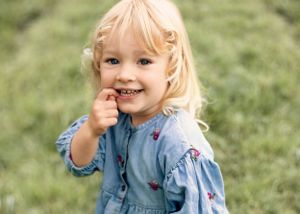 Outdoor location portrait of young girl in floral dress