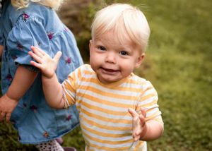 Fun baby portrait of little boy pulling a silly face