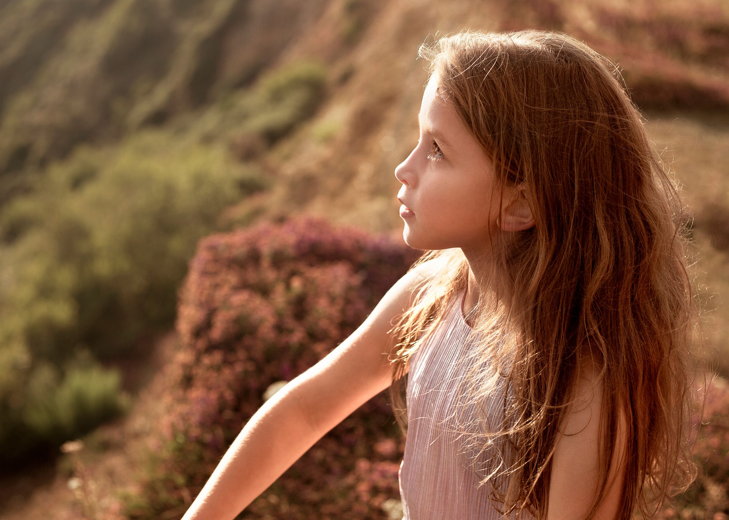 Young girl backlit by the sun on Jurassic Coastline