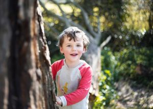 Beautiful natural light photography of young boy in woodland