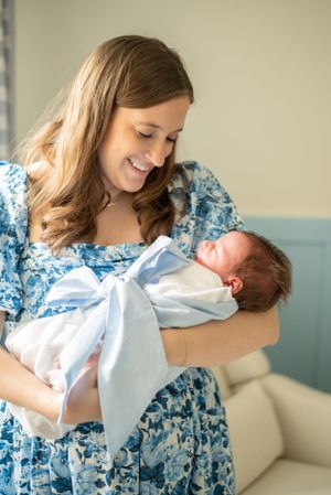 mama and baby boy cuddling during a Houston newborn photography session in house.