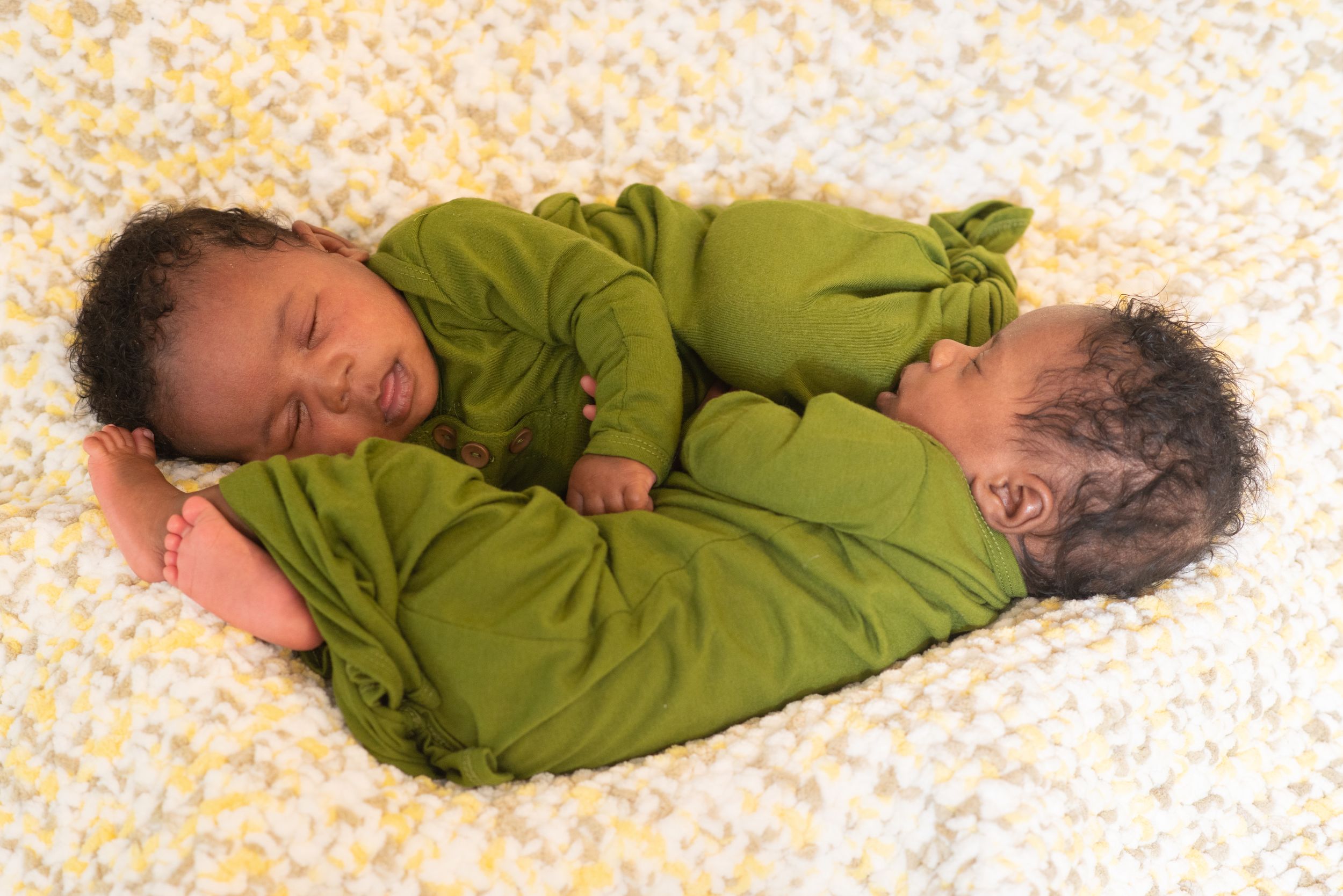 twins are two peas in a pod. Newborn baby twins next to each other during Houston newborn photography session