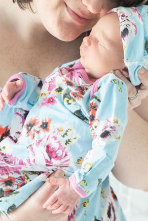 motherhood. First time mother loving their newborn baby during in home Houston photography session.