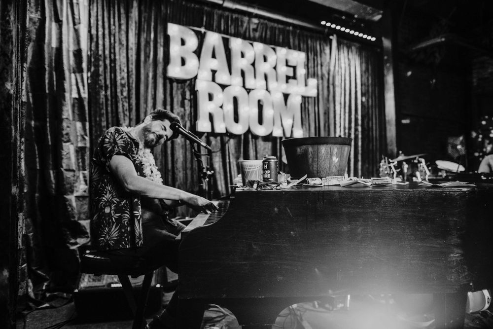 pianist plays during dueling piano show barrel room bar portland oregon brand photographer kimberly marie kimble