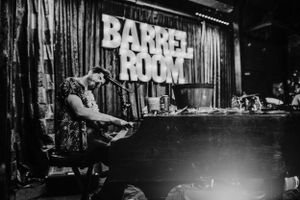 pianist plays during dueling piano show barrel room bar portland oregon brand photographer kimberly marie kimble