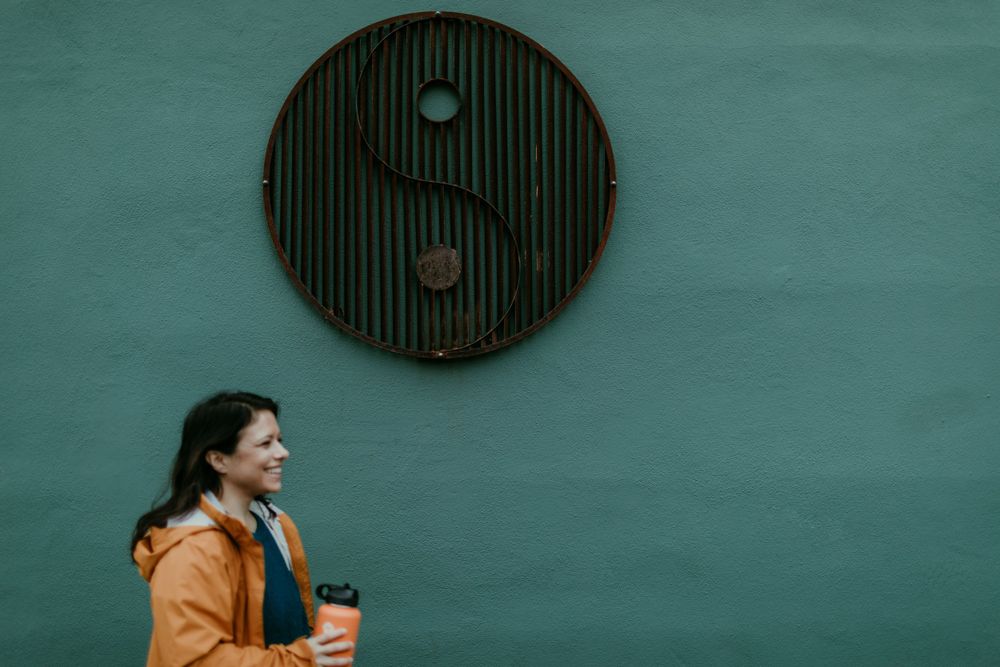 blurry image of woman walking past wall art installation portland oregon documentary photographer kimberly marie kimble