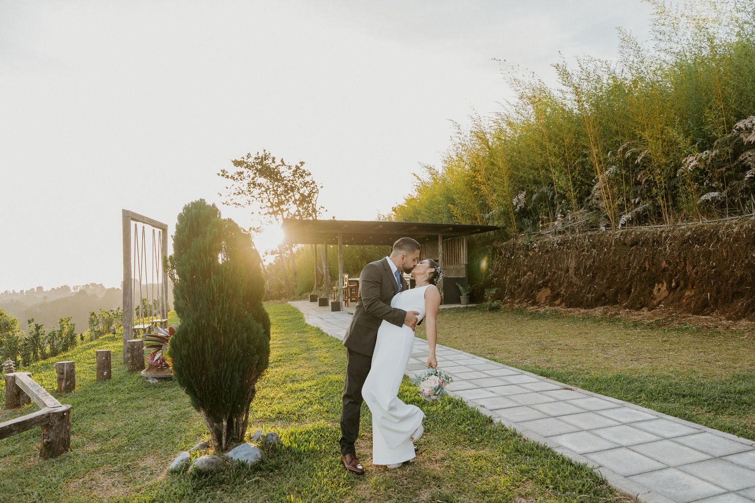 Sunset wedding ceremony on a stone path with dramatic backlight and greenery. alajuela, costa rica, sesión de esposos, boda, atardecer