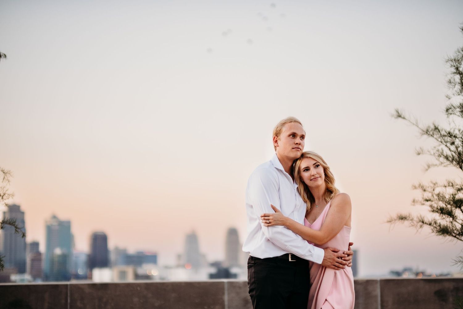 Couple poses for engagement photography session at the World War One Memorial in Kansas City, Missouri.