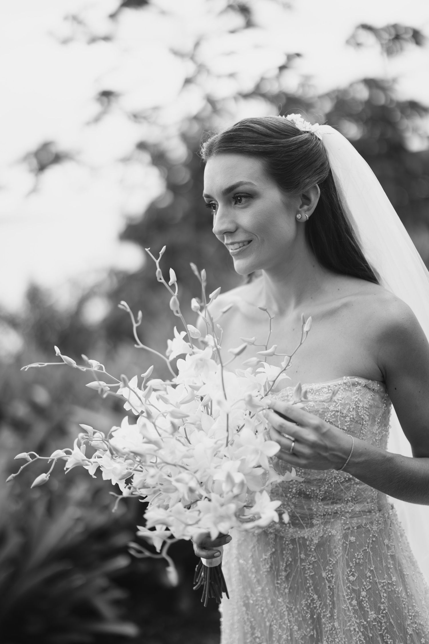 A delicate white orchid bouquet creating an artistic black and white composition.