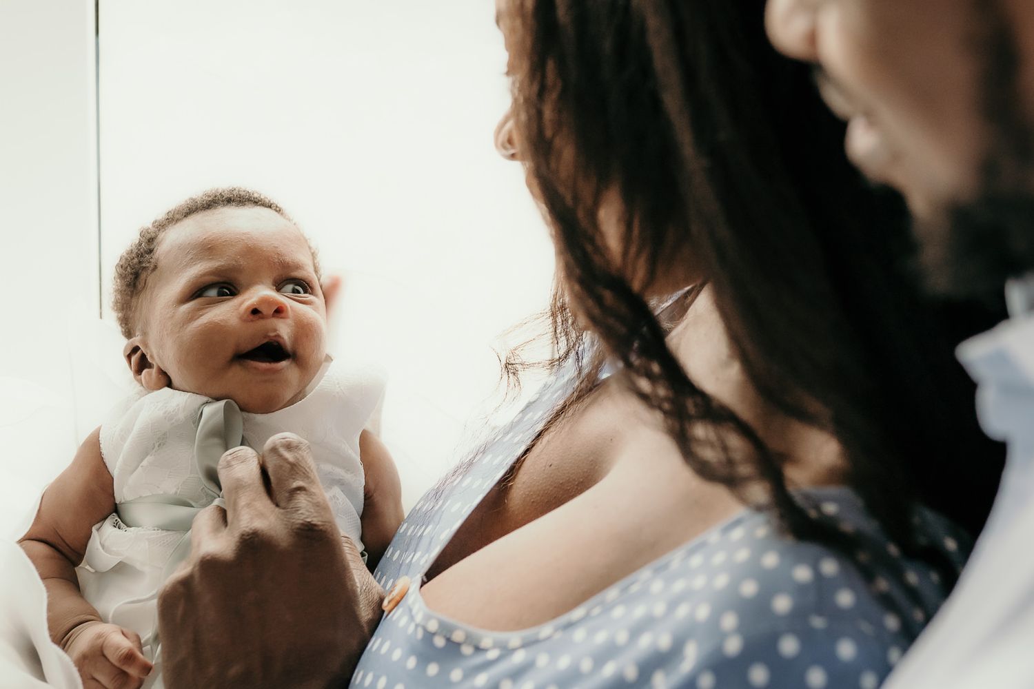 New parents making their newborn baby smile