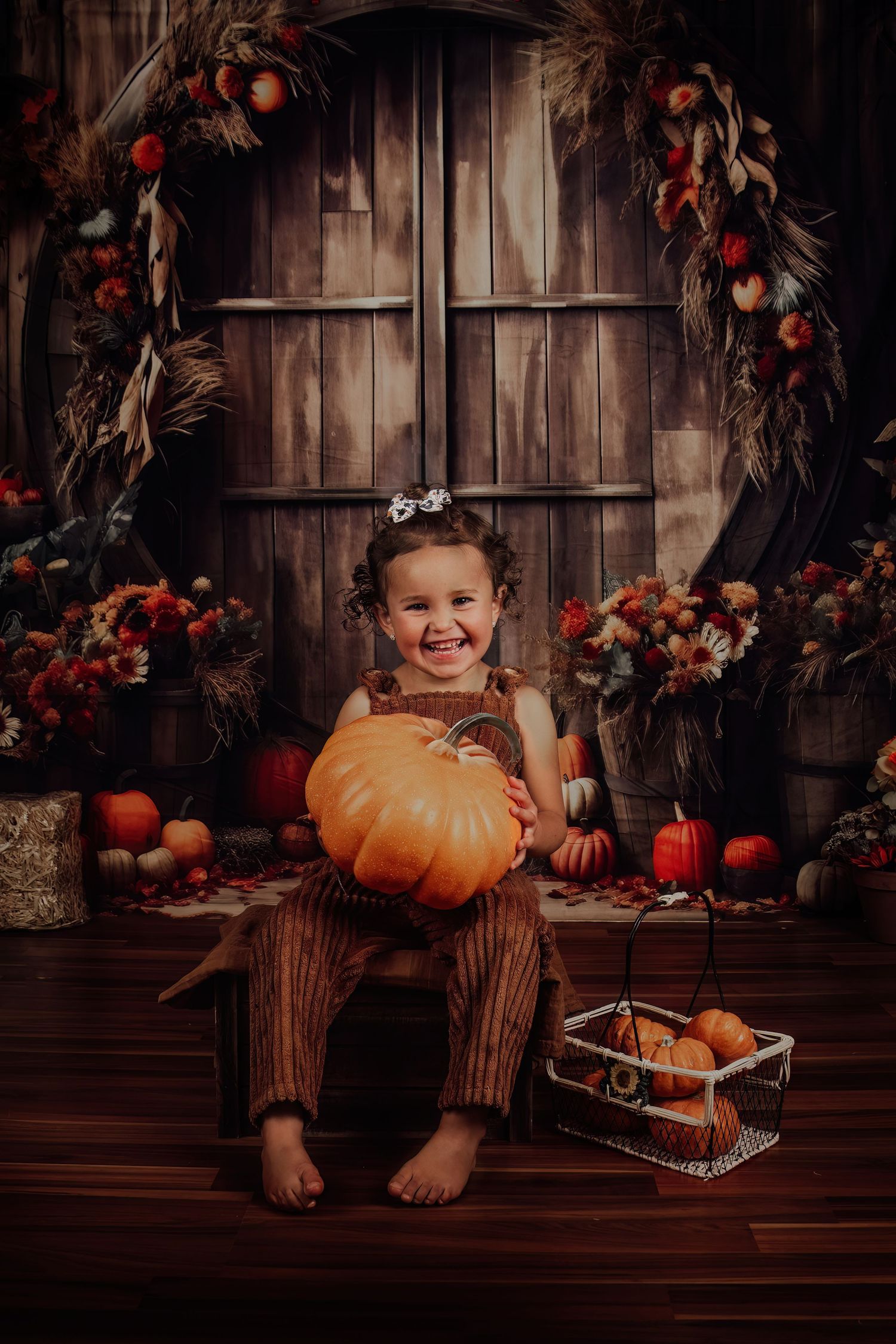 Rustic fall photography setup with wooden backdrop, autumn decor and pumpkins.