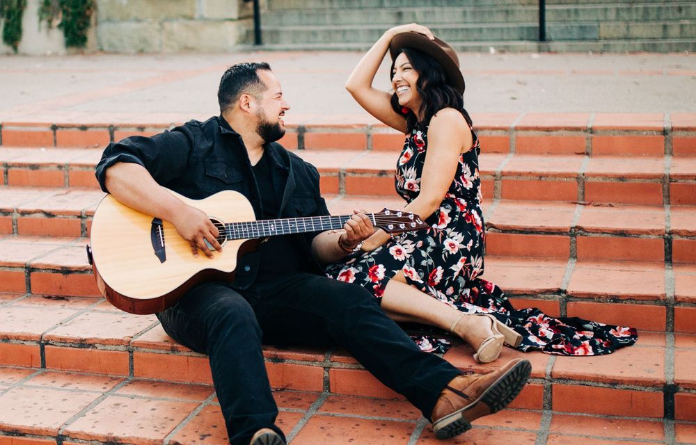 Matt serenading Erica on his guitar on the steps of Mission San Luis Obispo, California.
