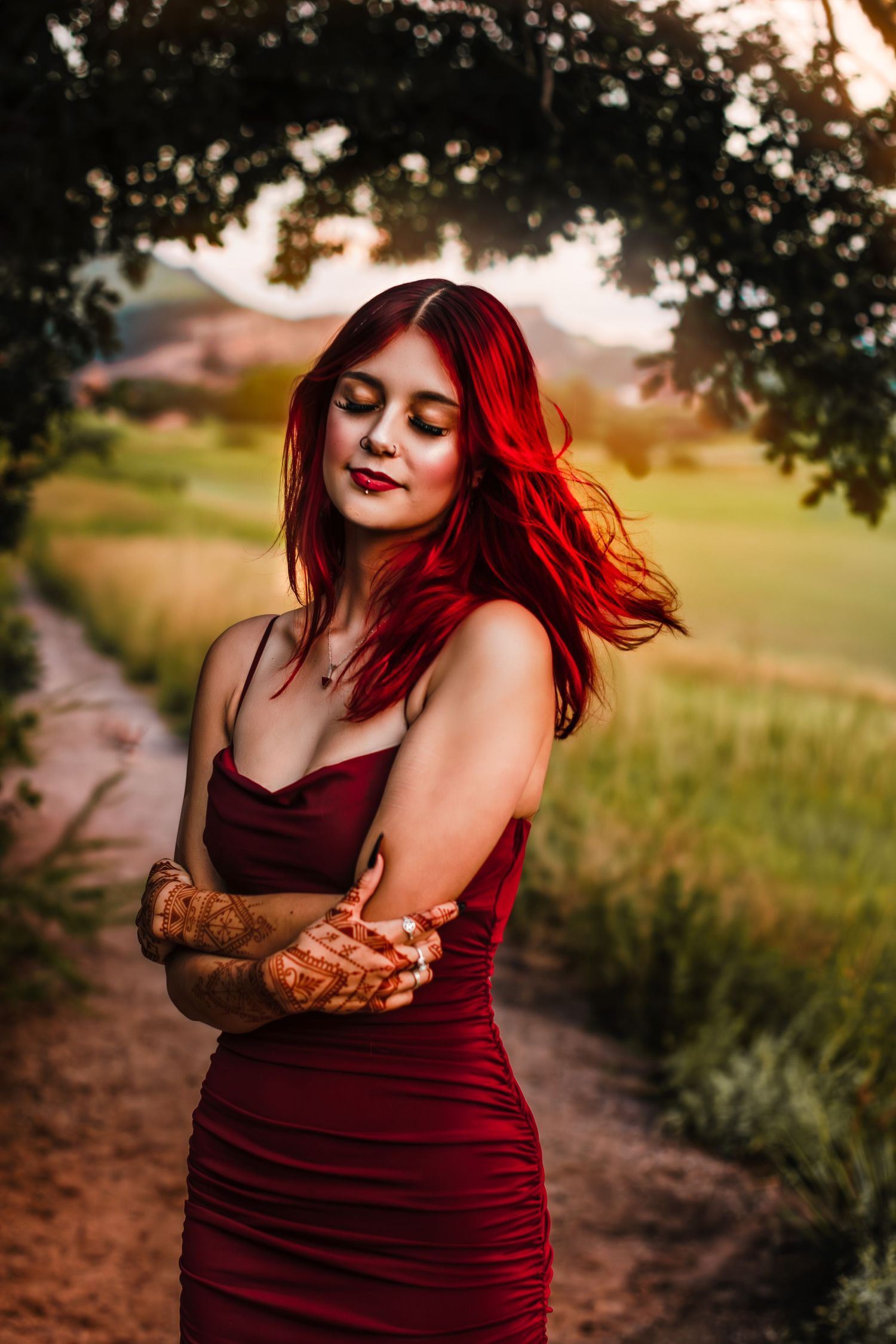 Teen girl with bright red hair swaying in a sunny field in South Valley Park, CO