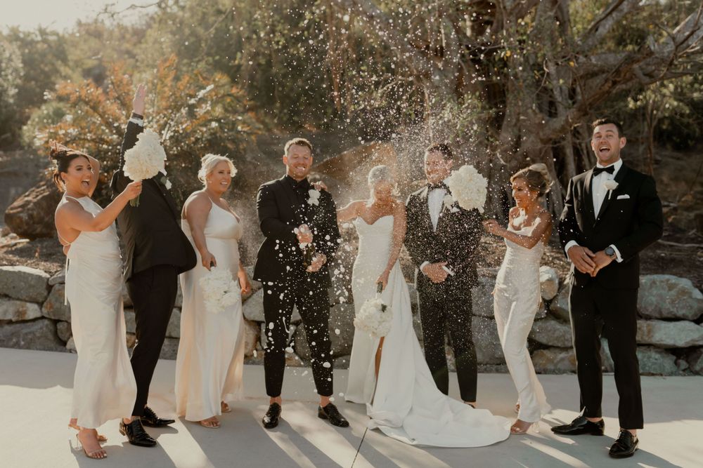 Bridal party champaigne pop on Hamilton Island.