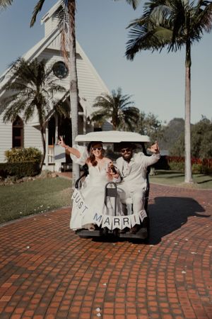 Wedding photography of couple in golf buggy on Hamilton Island.