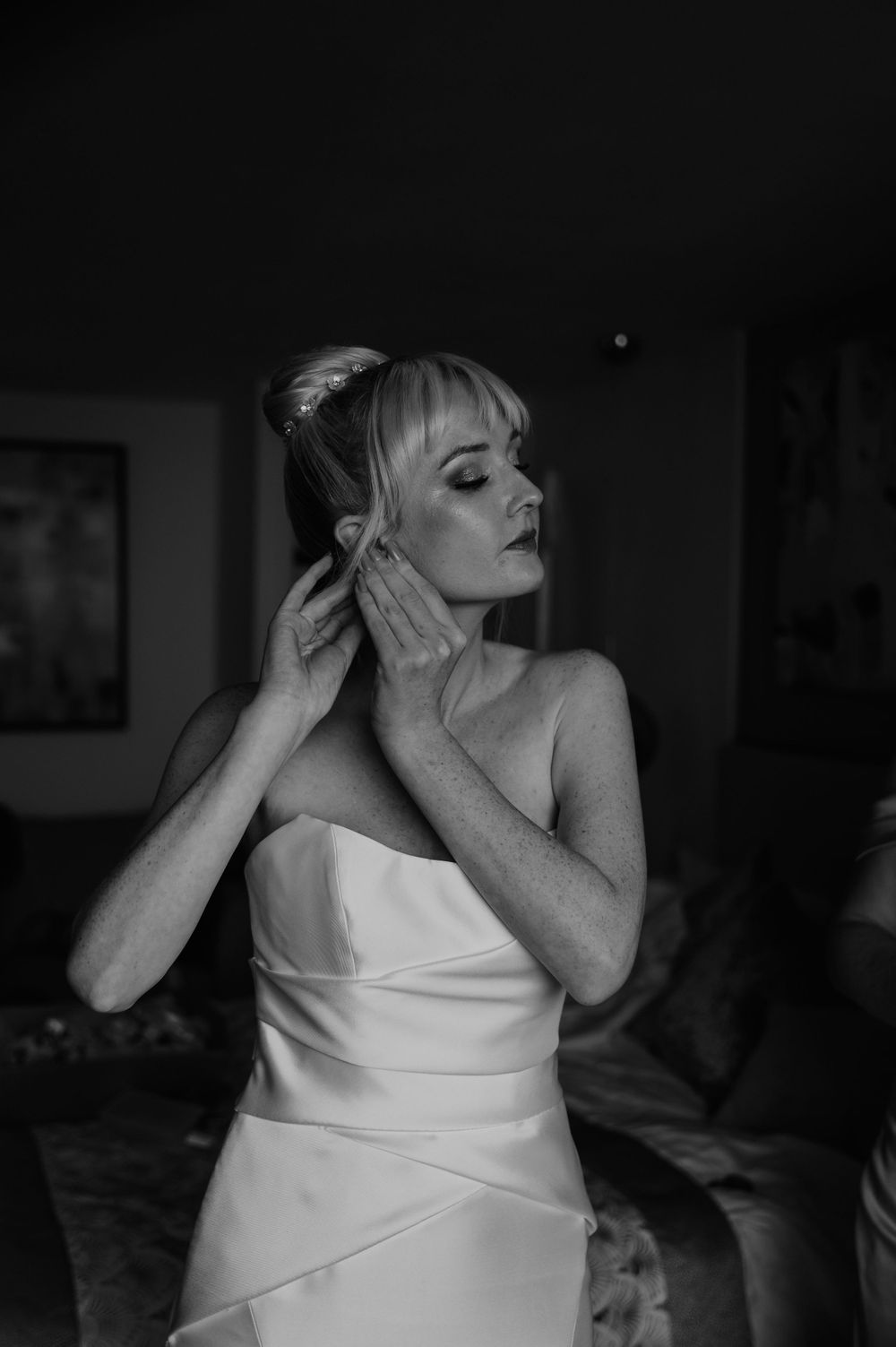 Sandy Cove Hotel wedding, the bride putting on her earrings