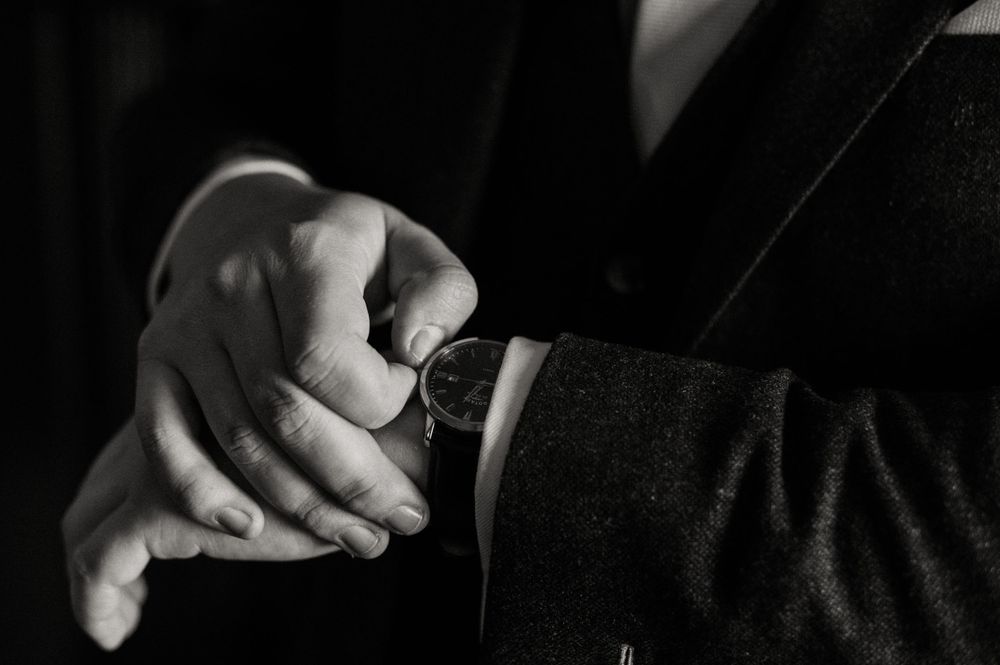 A groom adjusting his watch at Crowcombe Court