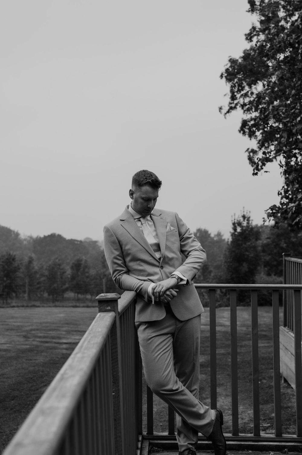 Deer Park Country Park wedding, the groom leaning against a fence waiting for the ceremony