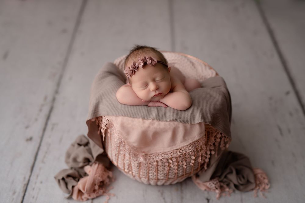 floral newborn session on white wood floor in studio lancaster pa