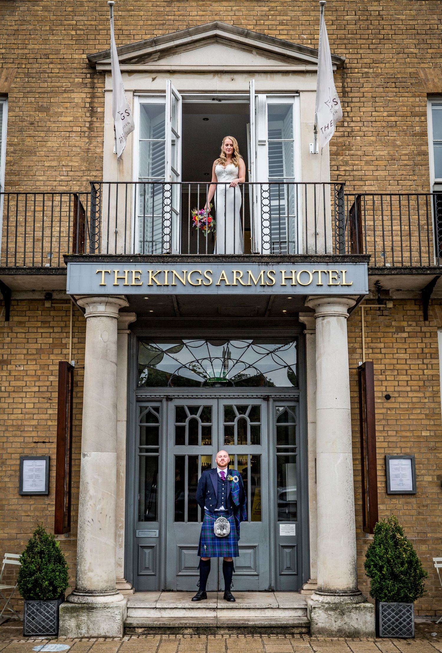 Exterior view of The Kings Arms Hotel with classic brick facade and columned entrance.