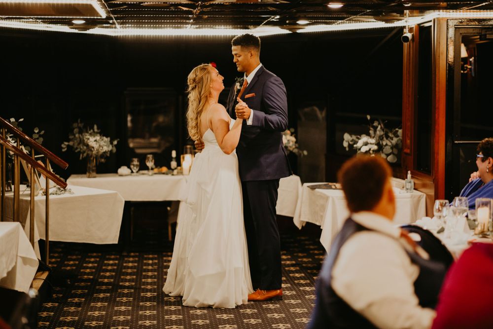 Bride and groom sharing a romantic first dance at elegant wedding reception venue.