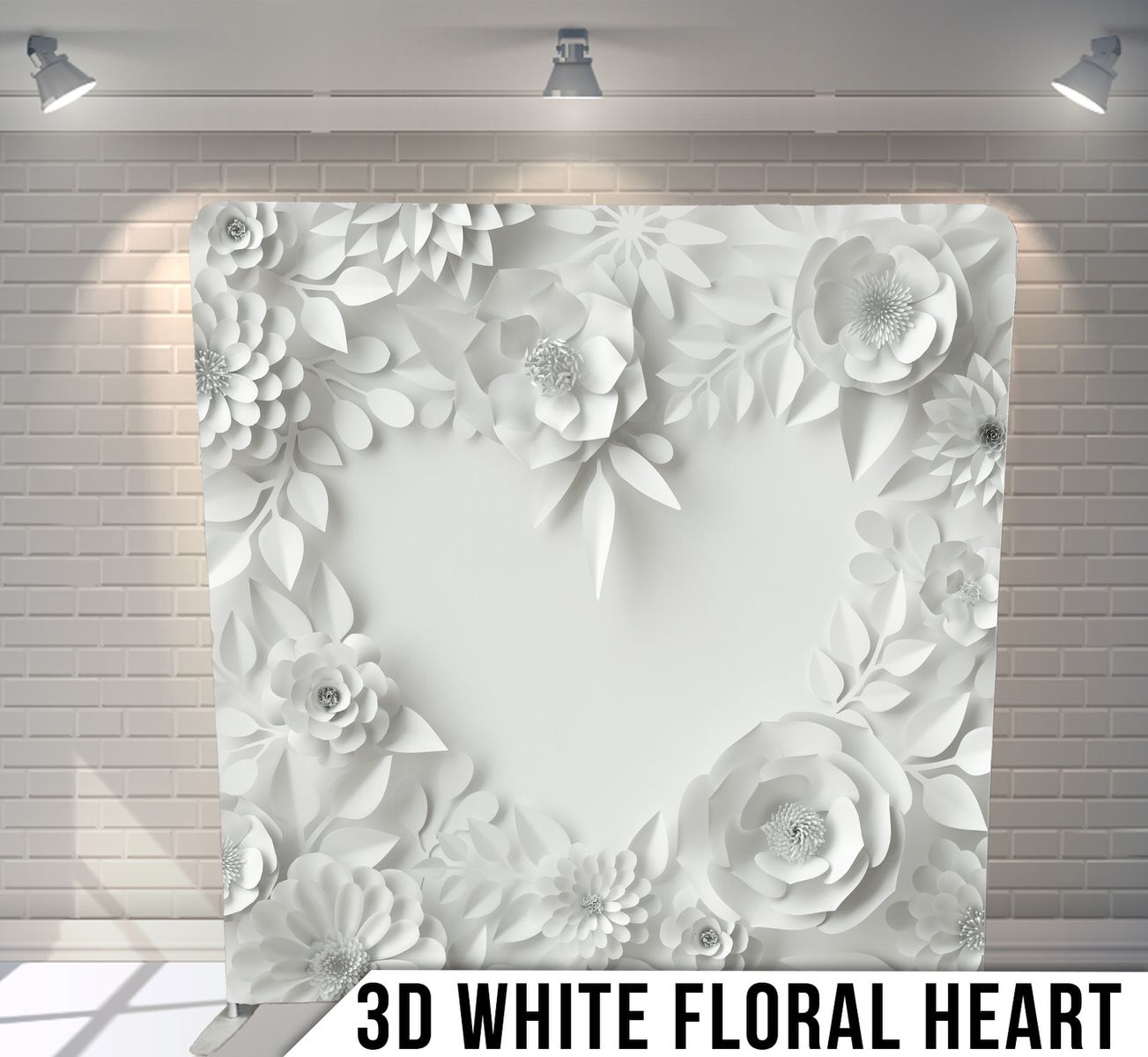 White 3D paper flowers and leaves arranged in a heart shape pattern against a light background.
