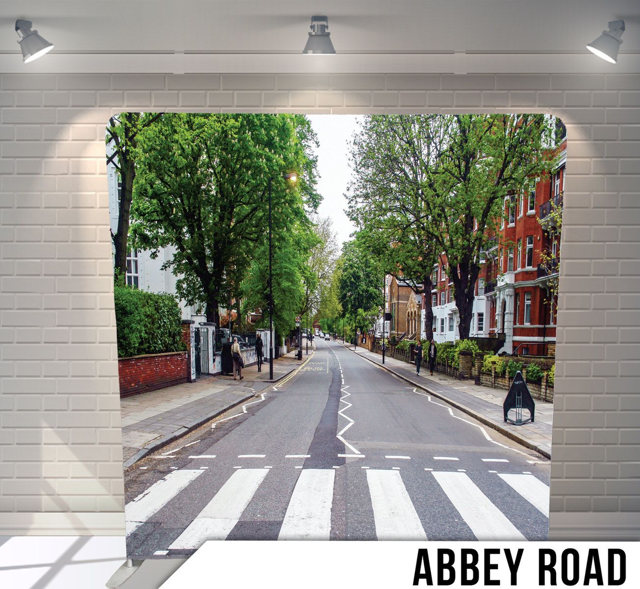 A tranquil tree-lined street view of Abbey Road in London with a zebra crossing and brick buildings on both sides.