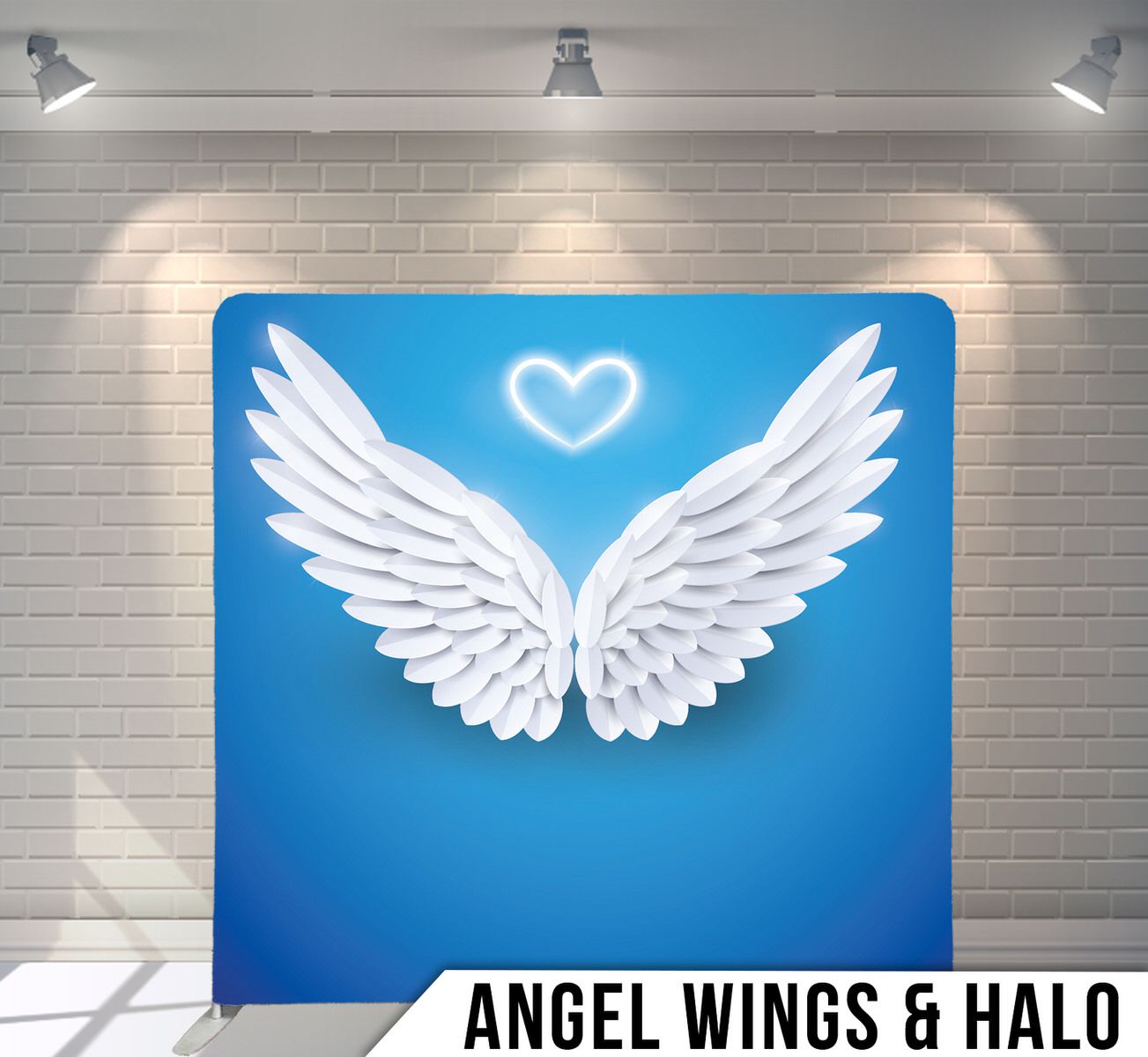 White angel wings with heart halo against bright blue background for photo backdrop.