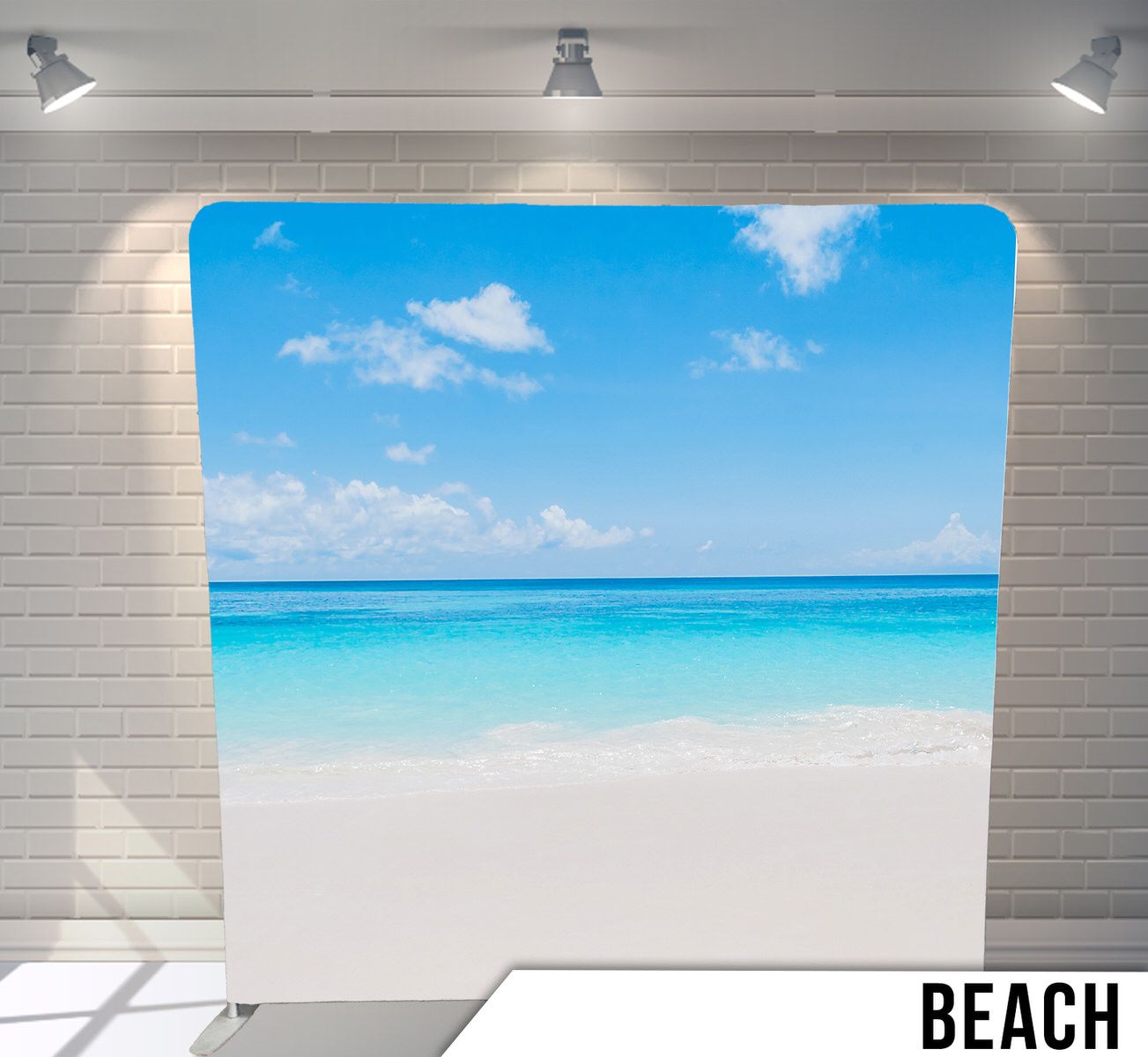 Pristine white sand beach meeting crystal clear turquoise waters under bright blue sky.