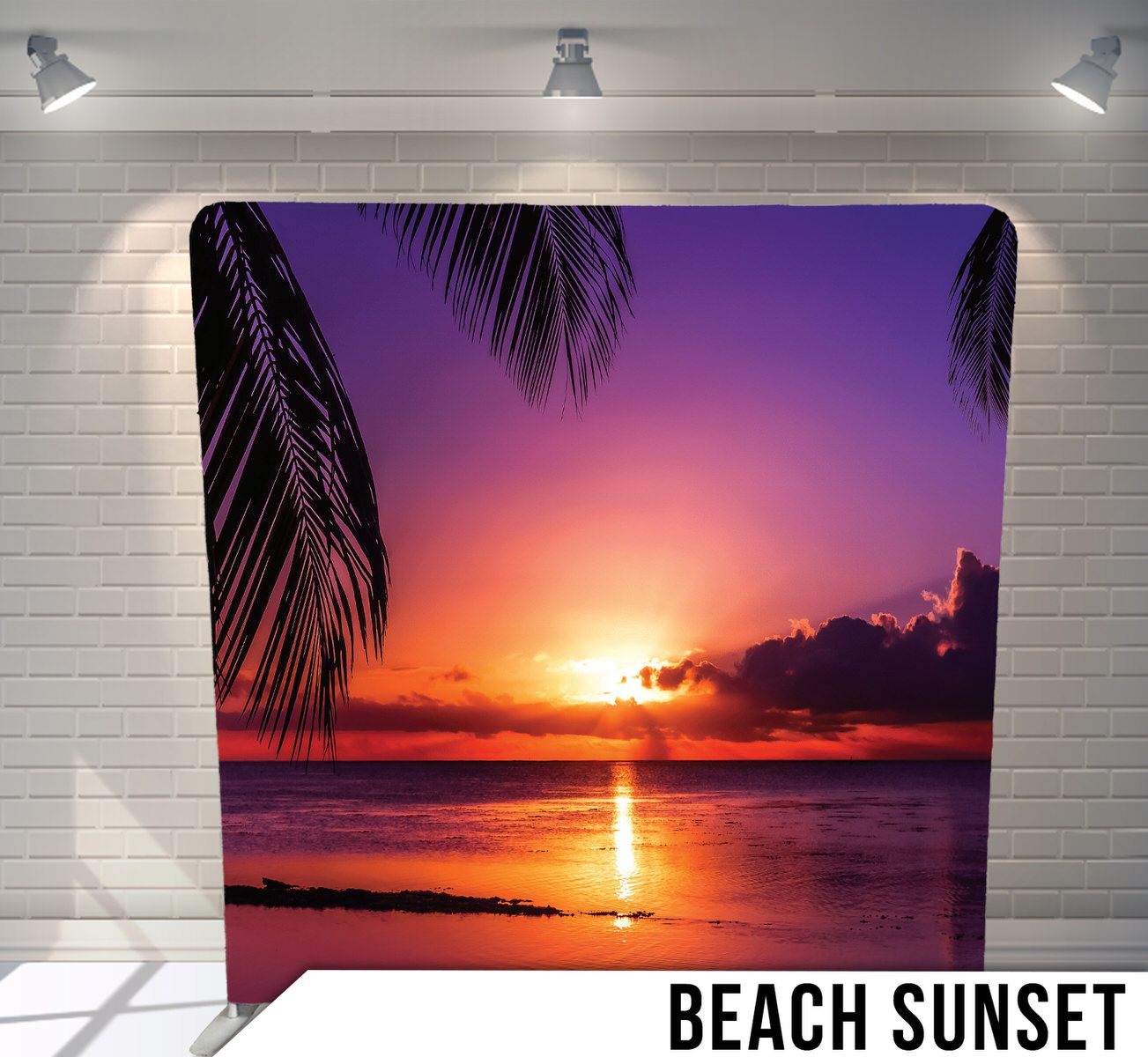 Dramatic purple and orange sunset over ocean water with silhouetted palm fronds in foreground.