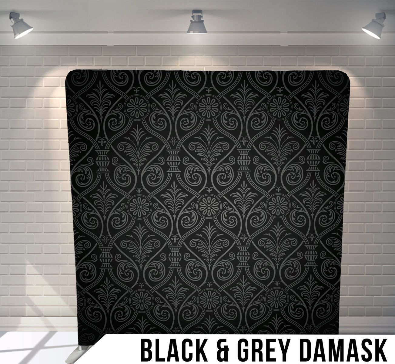 Elegant grey damask pattern on black background featuring intricate scrolling motifs.