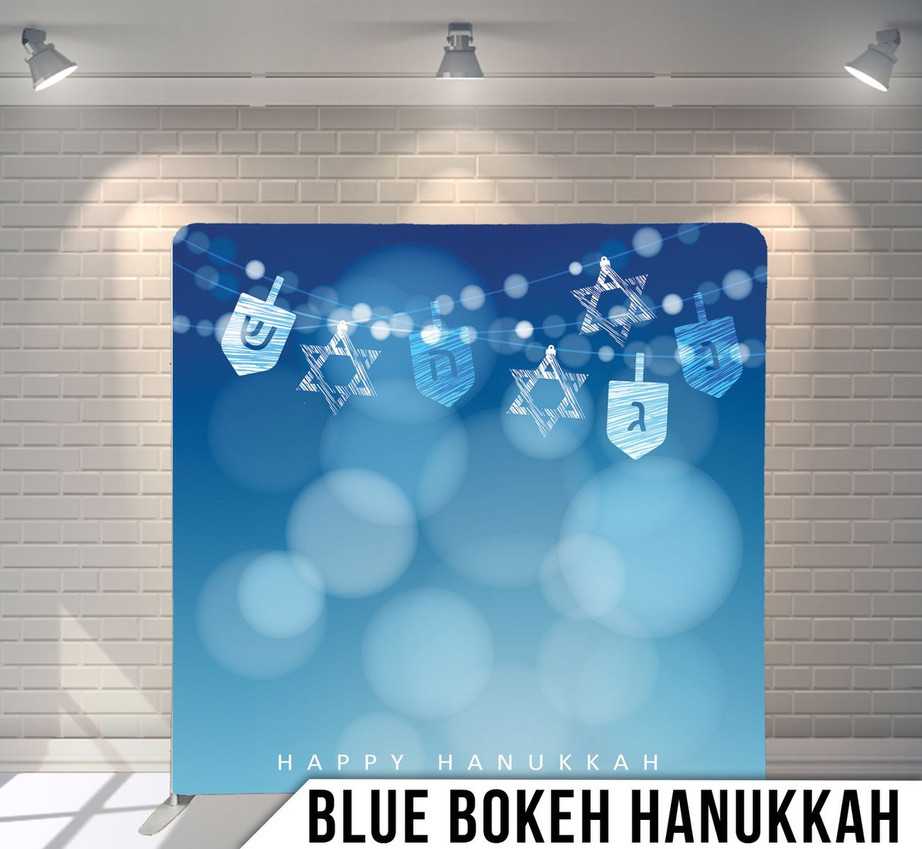 Hanukkah themed backdrop with dreidels and Star of David silhouettes on blue bokeh background.