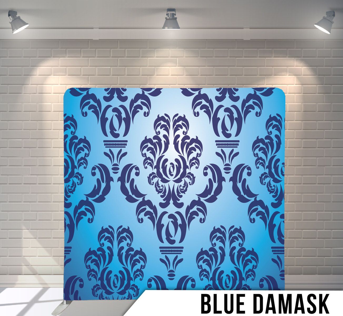 Elegant blue damask pattern backdrop with ornate floral designs in navy blue against a light blue background.