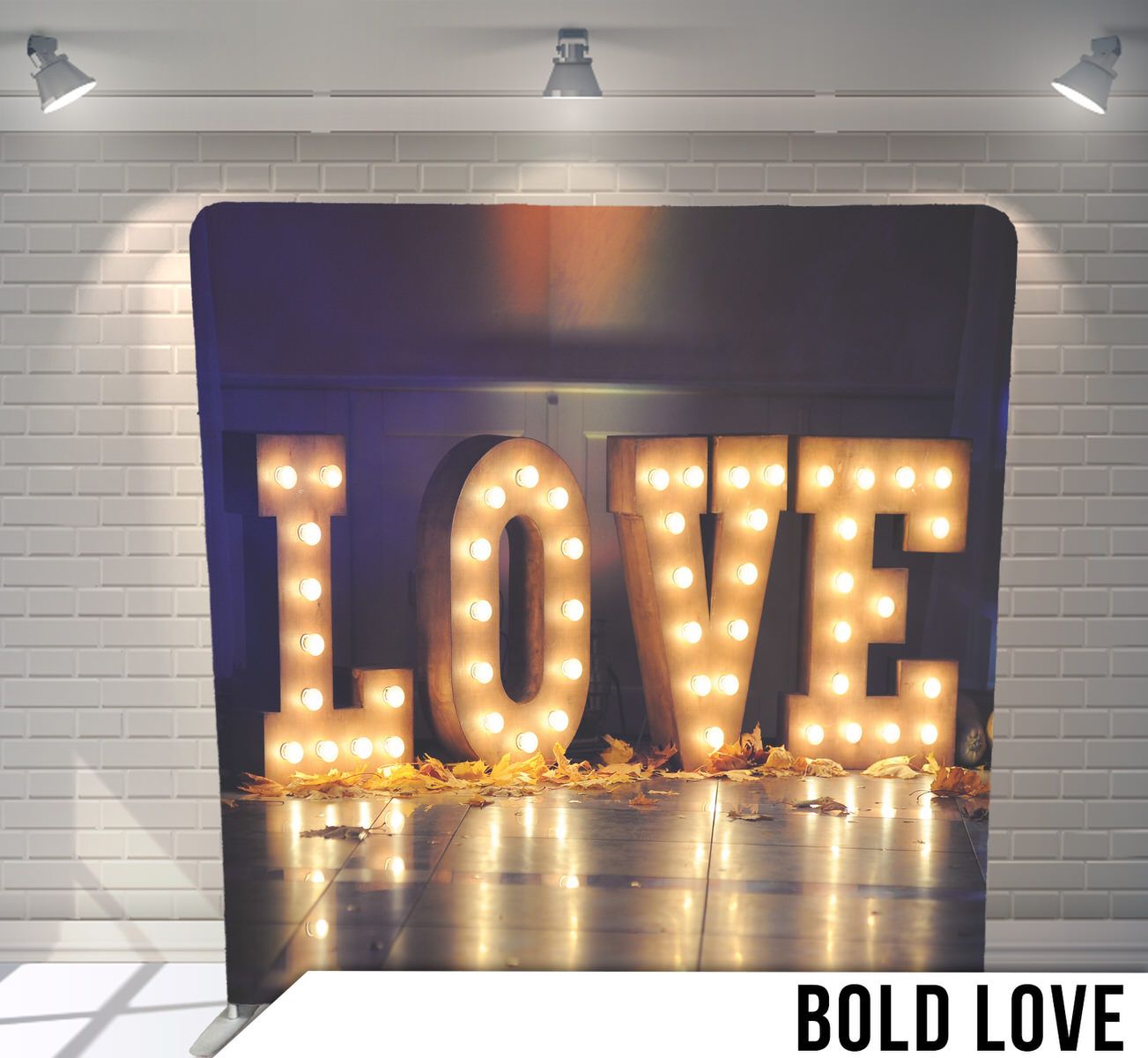 Illuminated LOVE marquee letters glowing warmly against a dark background.