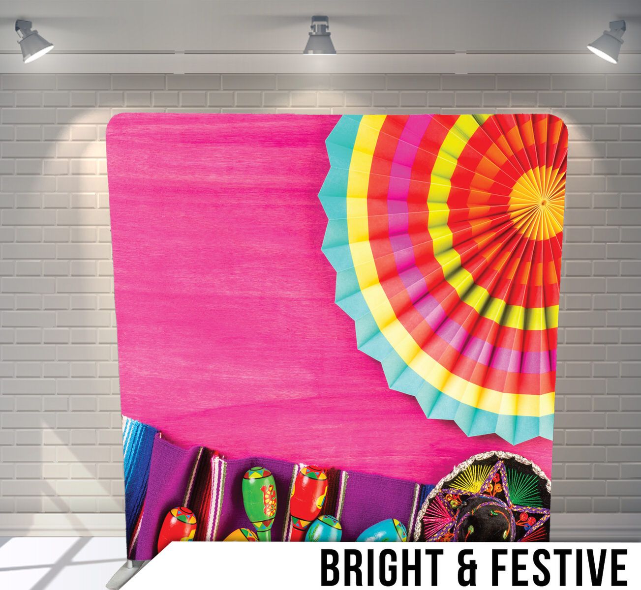 Vibrant paper fan decorations and festive ornaments against bright pink background.