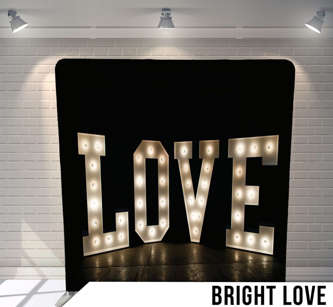 Illuminated marquee LOVE sign with glowing bulbs against black background.
