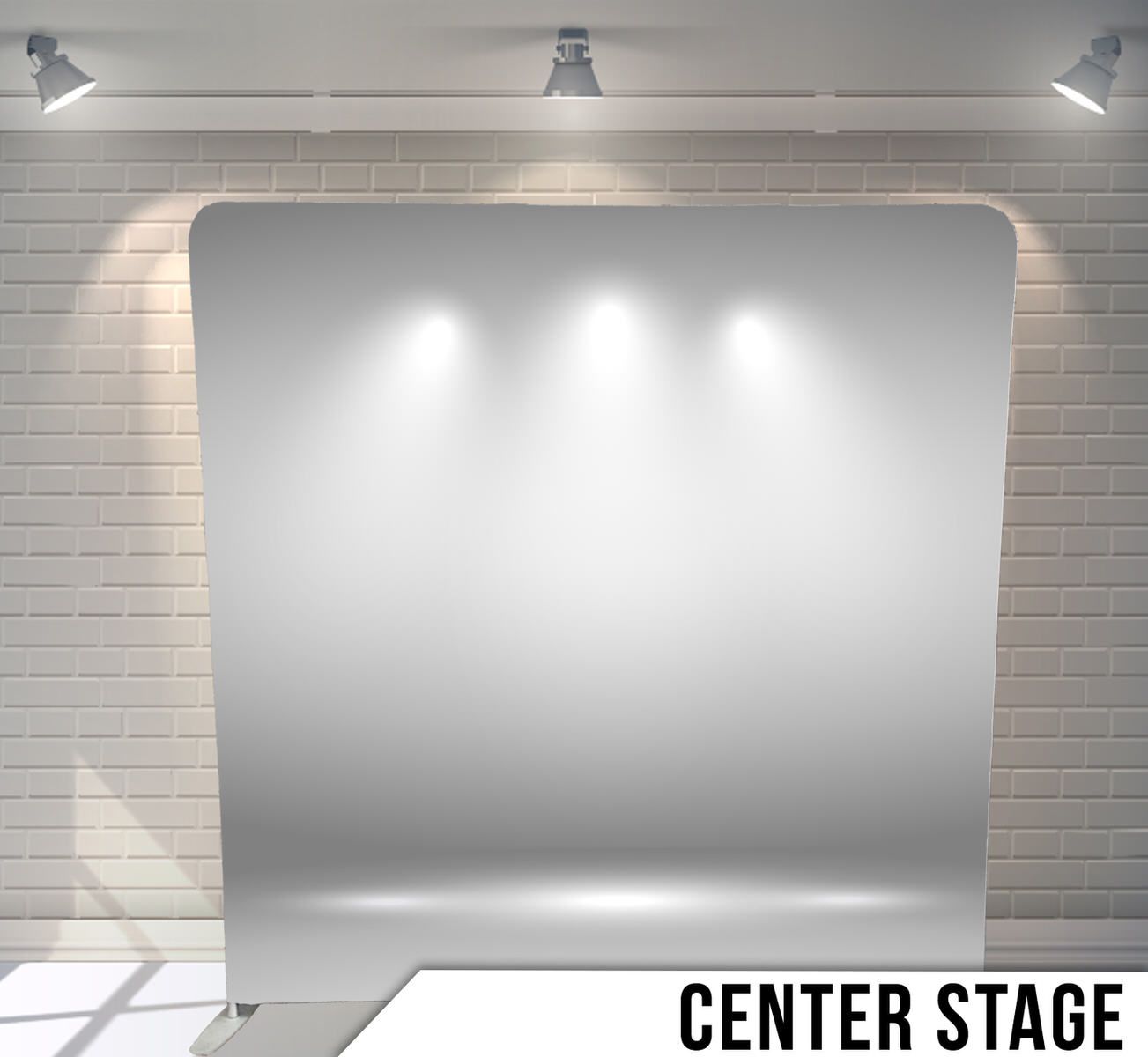 Plain gray backdrop with spotlights creating dramatic lighting effects on a stage-like setting.