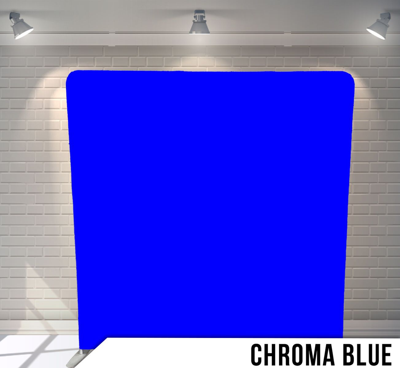 Solid chroma blue photography backdrop against white brick wall with studio lighting.